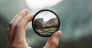 A stunning mountain landscape magnified through a handheld lens highlighting exploration and adventure.